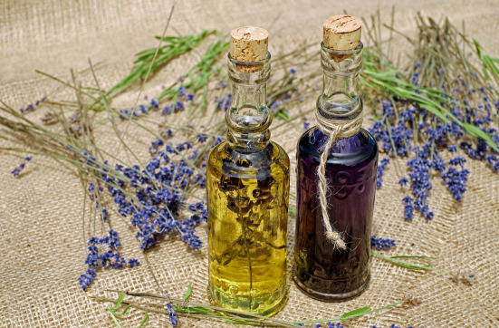 Warm-toned essential oil glass bottles on natural wood